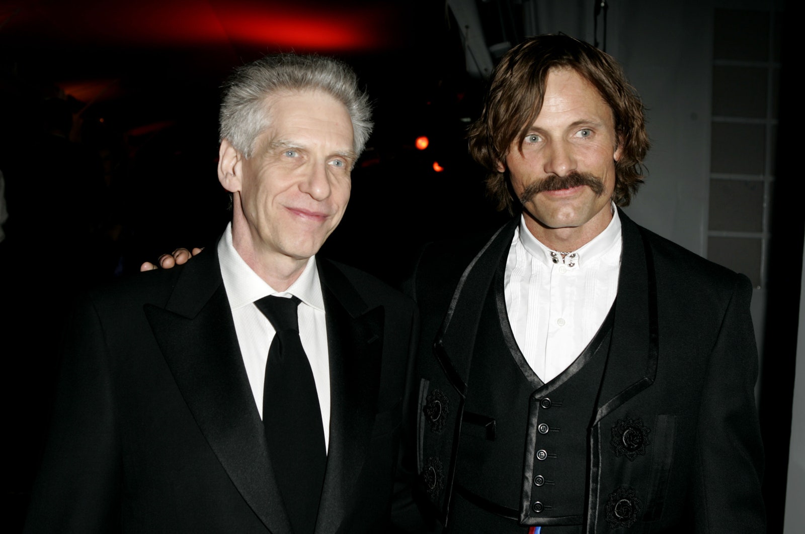 Image may contain David Cronenberg Viggo Mortensen Clothing Coat Formal Wear Suit Accessories Tie Jacket and Head