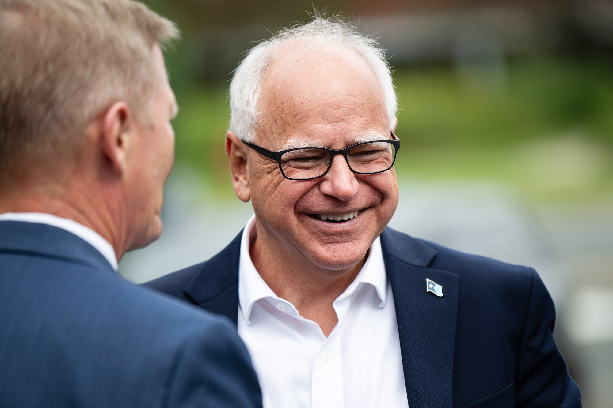 Image may contain Tim Walz Head Person Face Accessories Glasses Happy Smile Adult Laughing and Photography