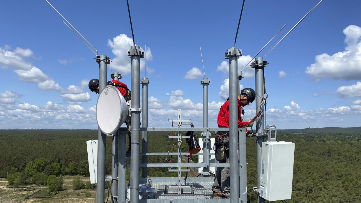 Arbeiter montieren auf einem Funkmast im Berliner Stadtteil Schmöckwitz in gut 50 Meter Höhe Antennen für die fünfte Mobilfunk-Generation (5G).