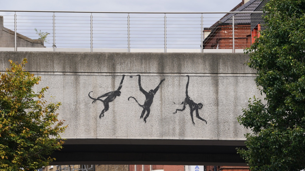 Ein Blick auf Banksys neues Kunstwerk, das drei Affen auf einer Brücke in der Brick Lane zeigt.