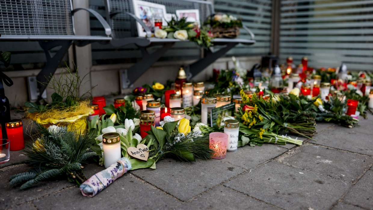 Blumen, Kerzen und verschiedene Bilder sind im Wartehäuschen am Bahnhof zum Gedenken an die Opfer der Messerattacke in Brokstedt niedergelegt.