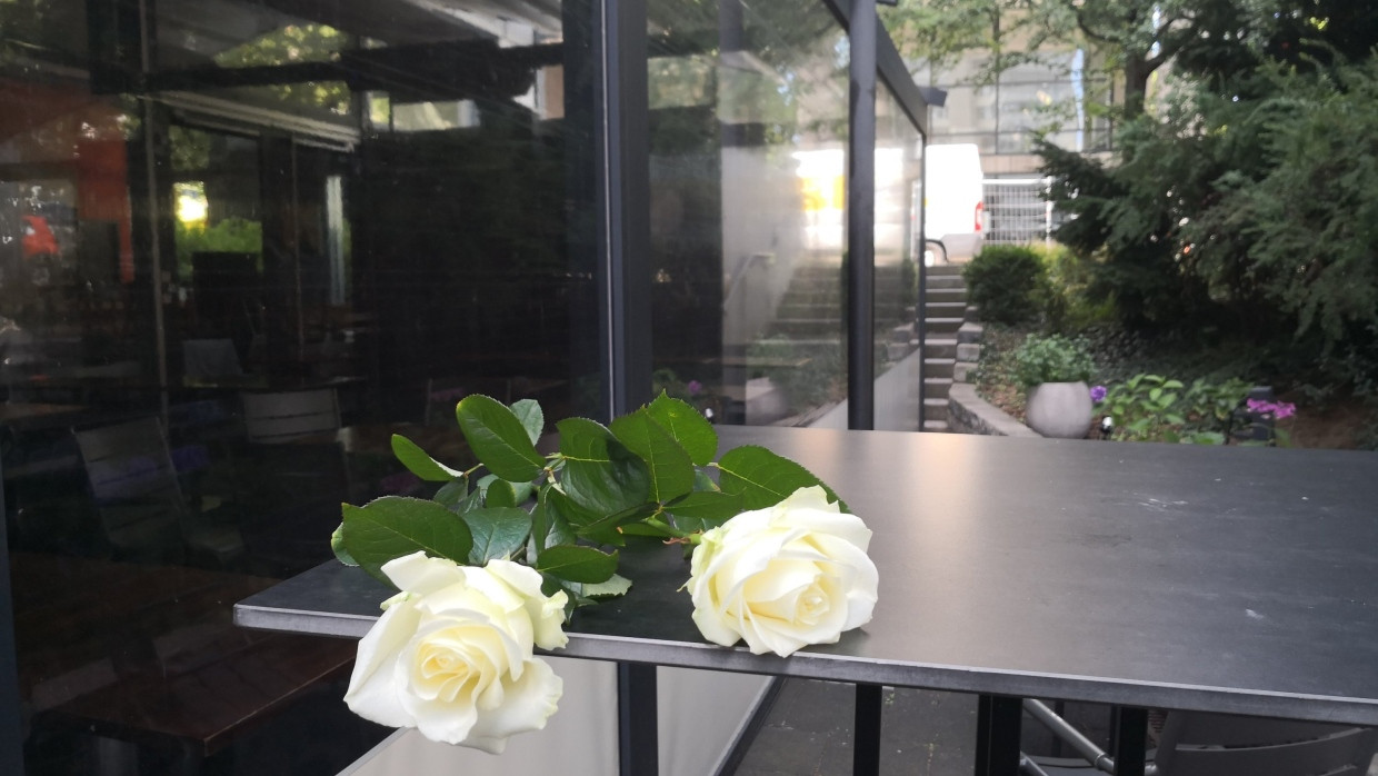 Zwei Rosen liegen auf einem Tisch vor einem Lokal in Stuttgart. Die Polizei fand in dem Gebäude am Montag zwei Leichen.