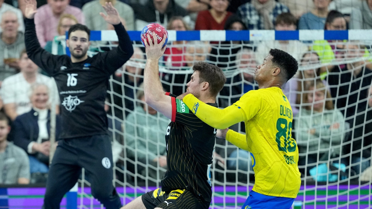 Deutschlands Johannes Golla (Mitte) und Brasiliens Edney Oliveira in Aktion während des Testspiels in Flensburg.