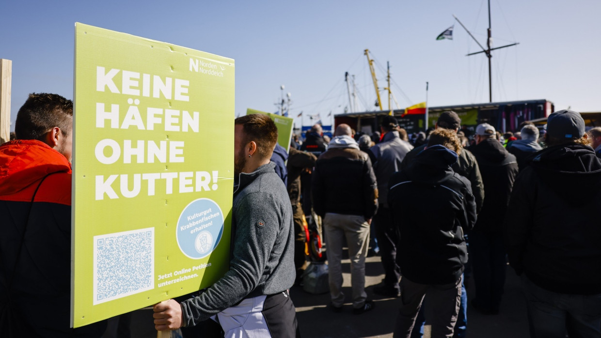 Teilnehmer einer Kundgebung stehen anlässlich der Agrarministerkonferenz zusammen.