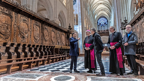 „Sehr bewegend“: Präsident Macron spricht Ende November bei einem Baustellenbesuch mit Erzbischof Ulrich (rechts neben ihm) und Philippe Jost, dem Vorsitzenden von „Rebâtir Notre-Dame de Paris“ (rechts neben Ulrich).