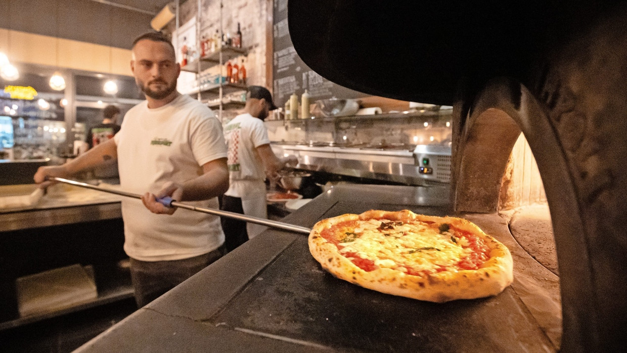 Nur echt mit Leopardenmuster:
  Bei den „Super Bro’s“ im Frankfurter  Nordend holt Marco Guadagno (links)  eine Pizza aus dem 450 Grad heißen Ofen. Die schwarzen Flecken am hohen Rand  und auf dem Boden sind Markenzeichen  der original neapolitanischen Machart.