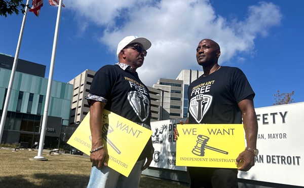 Mark Craighead (left) stands with Lamarr Monson during a rally to investigate former Detroit Detective Barbara Simon, who was involved in their wrongful convictions.