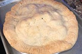 Home made apple pie cooling on a baking sheet