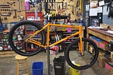 Partially built bicycle on a work stand in a bike shop