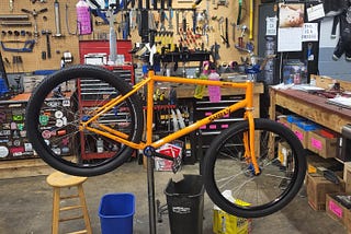 Partially built bicycle on a work stand in a bike shop