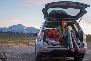 Nicole Jordan in the back of her van while outdoors.