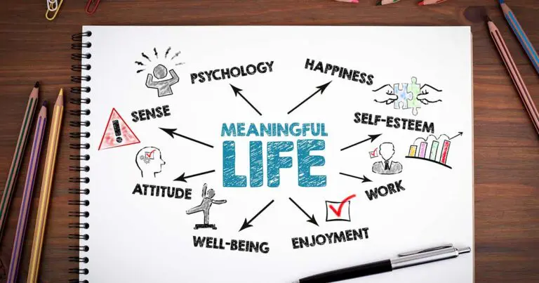 a spiral-bound notepad in landscape position on a desk with a mind map drawn on it with the words meaningful life at the center and surrounded by other related words like happiness and well-being to symbolize a personal definition of success