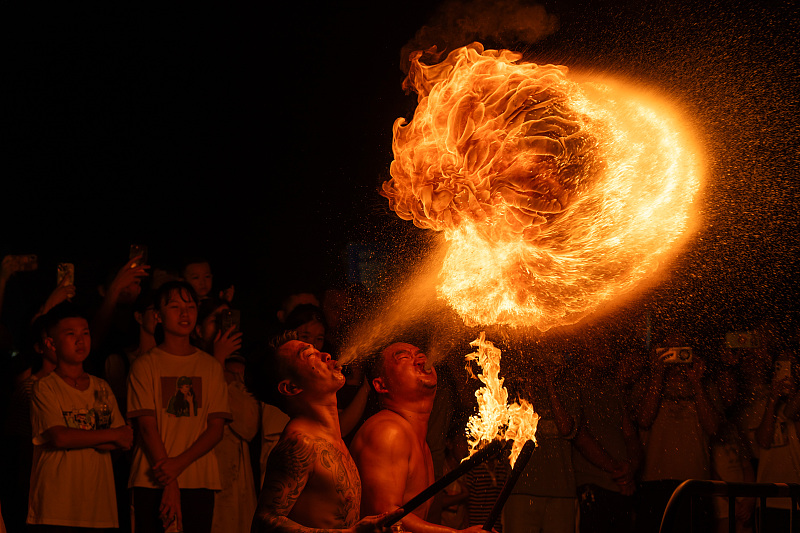 Performers showcase fire breathing stunts at a cultural performance in Foshan City, Guangdong Province, August 16, 2024. /CFP