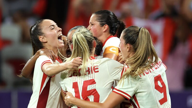 The Canadian women's soccer team celebrates during their win over Colombia Wednesday. The team has advanced into the Olympic quarterfinals amid an ongoing spying scandal involving the team's now-suspended head coach.