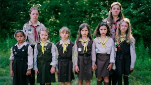 A group of “novachky” (female campers ages 6-11) stand at attention for a photograph, along with their two “sestrichky” (female counselors, translating to Sisters in English), as marching drills are part of daily activity at camp.