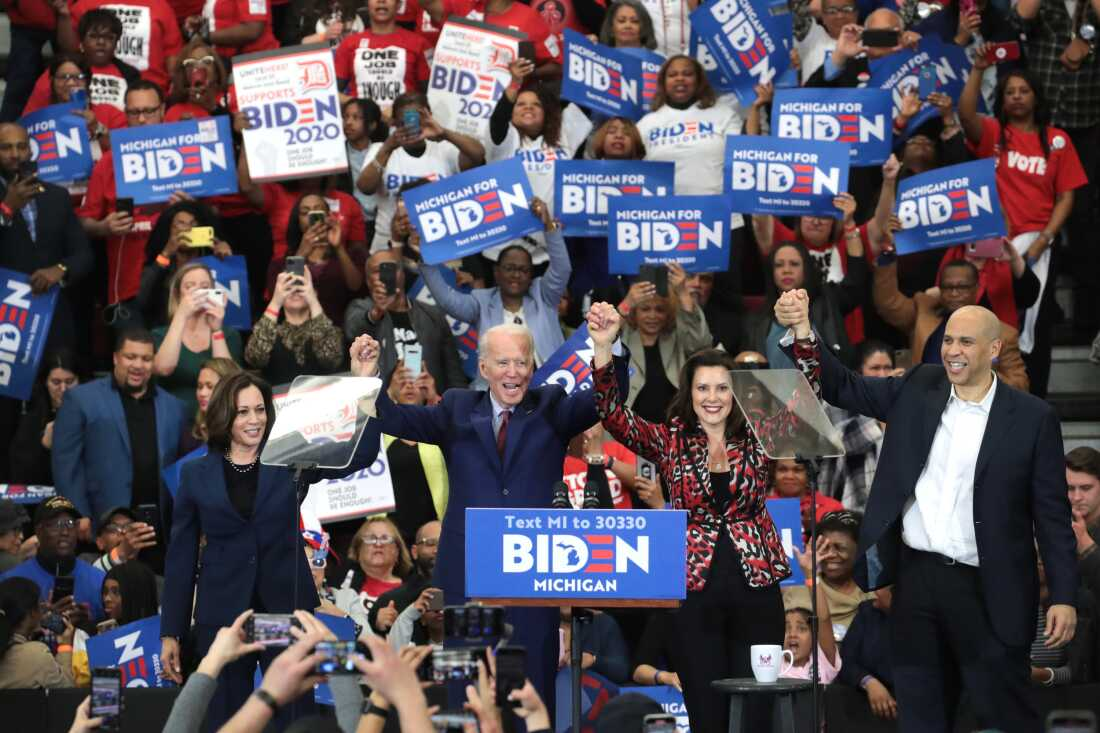 Then-Sen. Kamala Harris (L) (D-CA), Sen. Cory Booker (R)(D-NJ), and Michigan Governor Gretchen Whitmer joined Democratic presidential candidate former Vice President Joe Biden on stage at a campaign rally at Renaissance High School on March 09, 2020 in Detroit, Michigan.