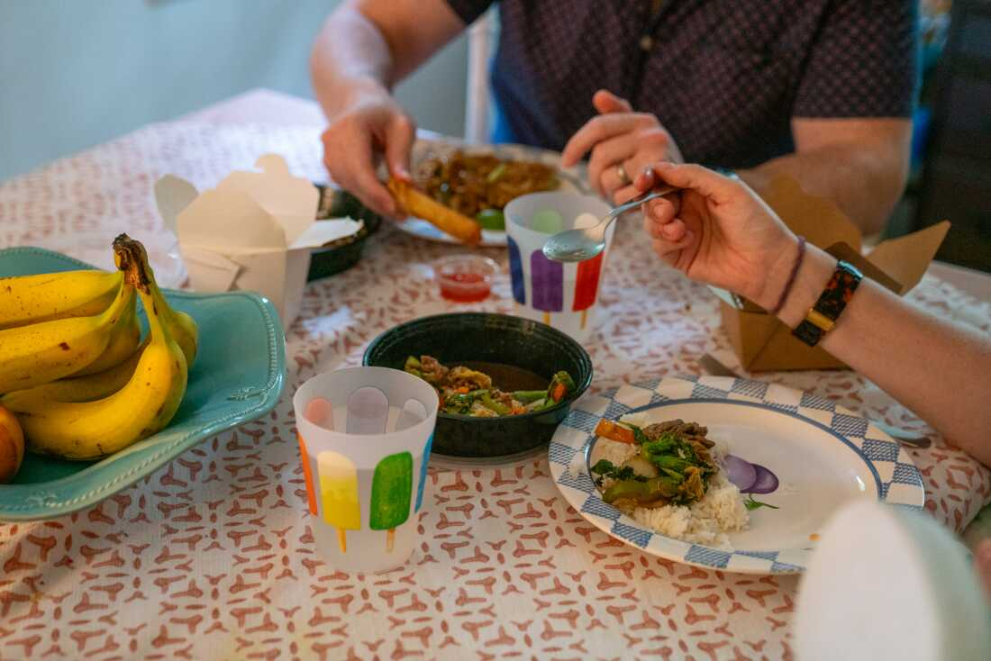 The du Plessises sit down for dinner, Thai food, which they had delivered.