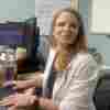 AtlantiCare nurse manager Kathryn Dixon sits with her laptop at a desk.