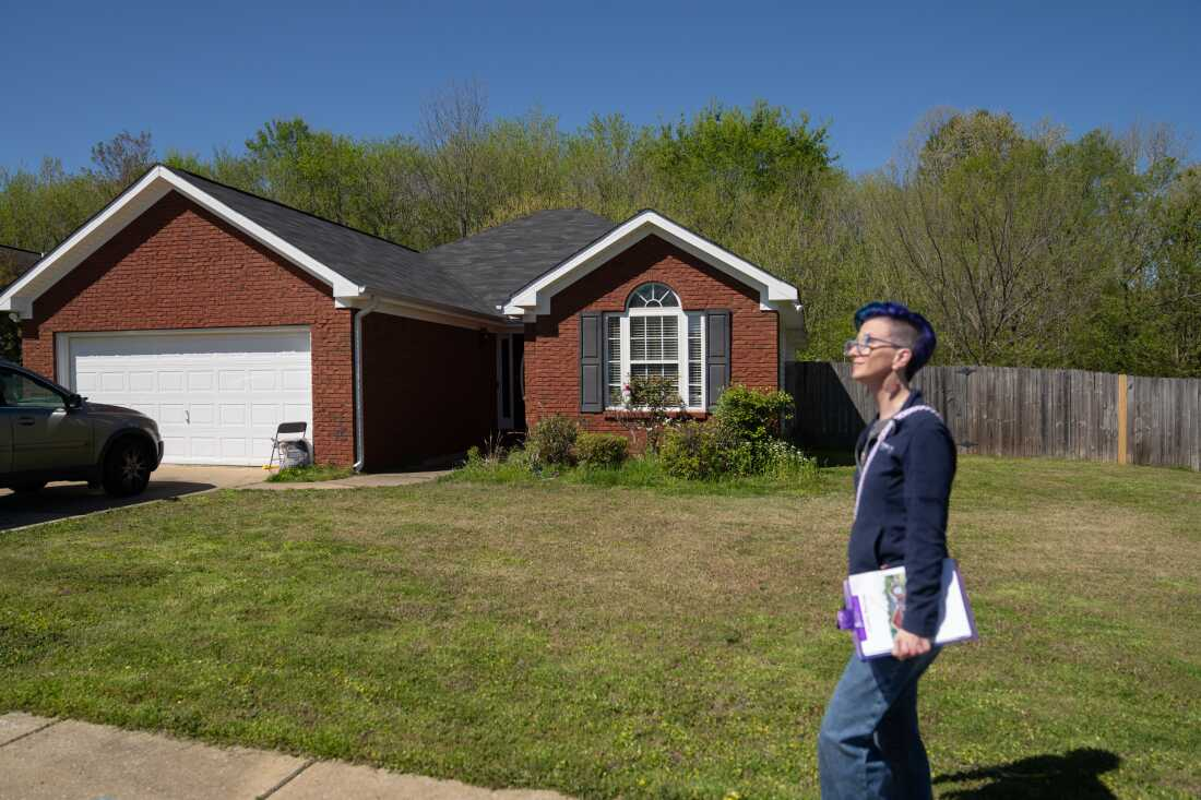 Glasgow stands on the sidewalk outside Clark's home on a corner lot in a Tuscaloosa neighborhood.