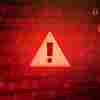 An ominous red background with and a caution symbol suggest danger online.