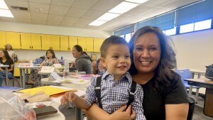 Elvia Elena Nunez and her grandson Esteban sit in a classroom in Phoenix.