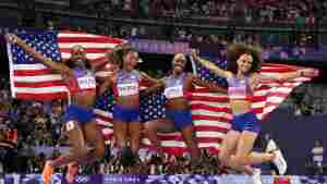 Alexis Holmes, Gabby Thomas, Shamier Little and Sydney McLaughlin-Levrone (L-R) of Team USA celebrate winning the Gold medal in the Women's 4 x 400m Relay Final on Saturday at the Stade de France.