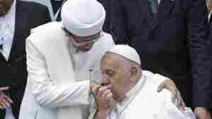 Pope Francis (right) kisses the right hand of the Grand Imam of Istiqlal Mosque Nasaruddin Umar after an interreligious meeting with faith leaders at the Istiqlal Mosque in Jakarta, Thursday.