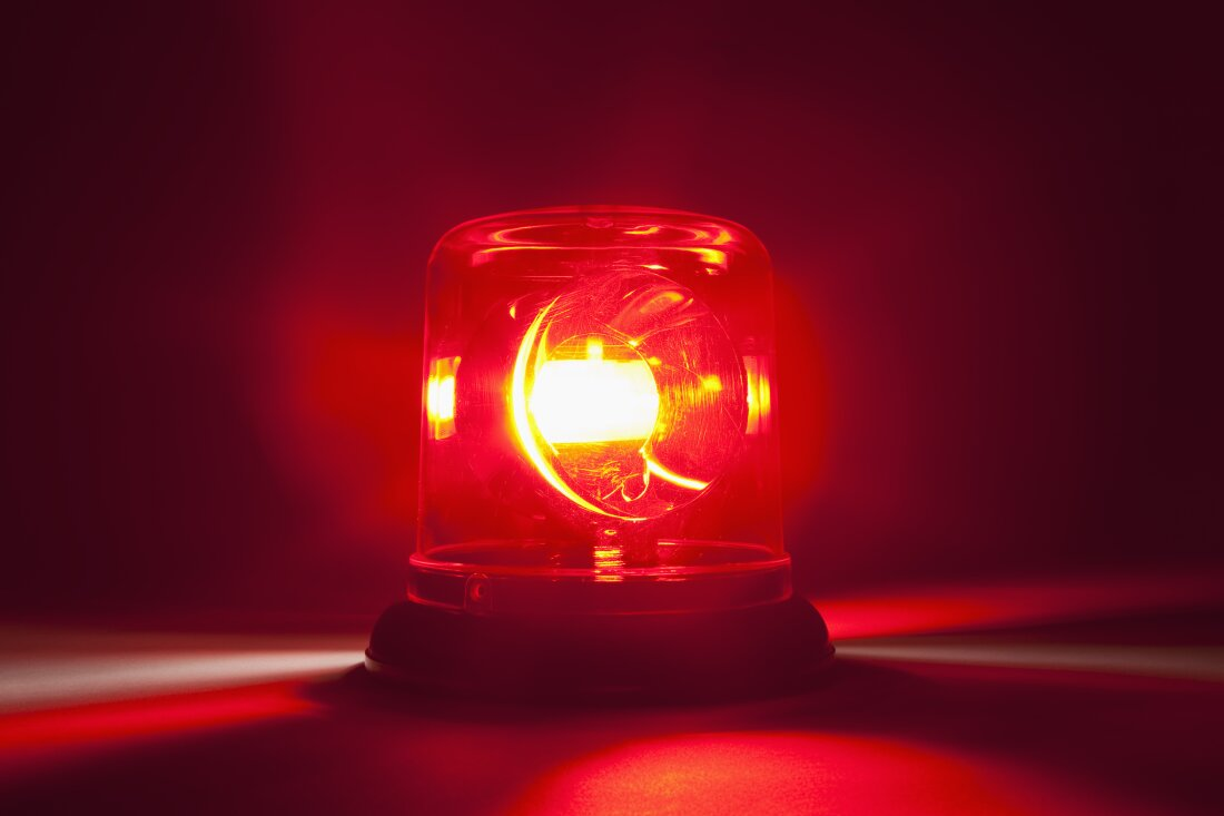 A picture of a red siren light in close up. 