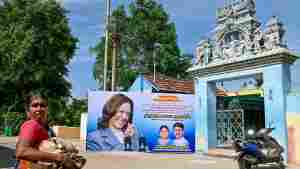 A woman walks past a poster of US Vice President Kamala Harris in her ancestral village of Thulasendrapuram in the south Indian state of Tamil Nadu on July 23, after she was endorsed for the fall presidential election.