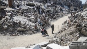 People are seen among rubble in the Jabalia refugee camp, northern Gaza Strip, on July 21, 2024. (Photo by Mahmoud Zaki/Xinhua via Getty Images)