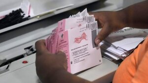 An election worker prepares mail-in ballots at the Clark County Election Department on Nov. 8, 2022, in Las Vegas. The Republican National Committee has filed a federal lawsuit seeking to prevent Nevada from counting mail ballots received after Election Day, as the state's law currently permits.