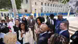 The Fearless Fund, an Atlanta-based venture capital firm, will shutter its grant program for Black women as part of a settlement, ending a year-long affirmative action battle. Here, co-founders and CEOs of The Fearless Fund Arian Simone (center left) and Ayana Parsons (center right) speak to journalists outside federal court in Miami on Jan. 31.