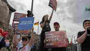 Anti-abortion protesters stand outside of the Republican National Convention in Milwaukee, Wisconsin, in July. Young people hold signs that say 