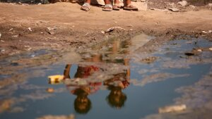 Palestinian children are sitting on a street flooded with sewage water in Deir el-Balah, in the central Gaza Strip, on July 23, 2024.  Polio was detected in multiple samples of Gaza's wastewater and now infectious disease experts suspect there are mild cases of the disease already in the population.  The World Health Organization says it is ''extremely worried'' that diseases, such as polio,  could cause more deaths than war injuries. 