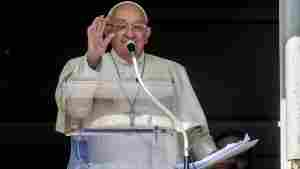 Pope Francis appears at his studio window for the traditional noon blessing of faithful and pilgrims gathered in St. Peter's Square at The Vatican, Sunday, Oct. 6, 2024.