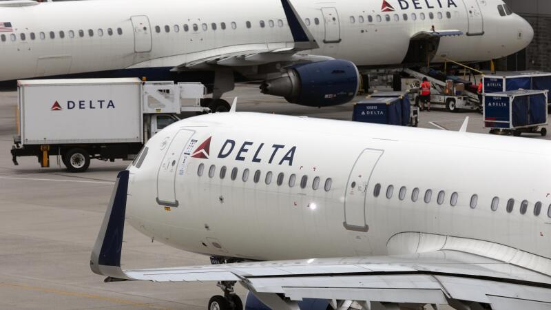 In this photo, a Delta Air Lines plane leaves the gate on July 12, 2021, at Logan International Airport in Boston. The plane is white and bears Delta's name and logo toward the front.