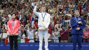 The new Michael Phelps may be a Frenchman. Gold medalist Leon Marchand stands with silver medalist Tomoyuki Matsushita (left), of Japan, and bronze medalist Carson Foster, of the United States, following the men's 400-meter individual medley final at the 2024 Summer Olympics on Sunday in Nanterre, France.