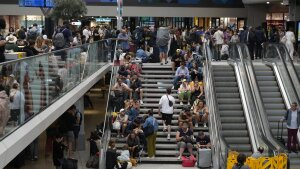 Travelers sit on stairs at the Gare de Montparnasse, at the 2024 Summer Olympics, Friday, July 26, 2024, in Paris, France. Hours away from the grand opening ceremony of the Olympics, high-speed rail traffic to the French capital was severely disrupted on Friday following what officials described as 