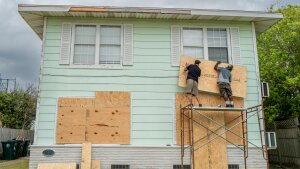 Dane Allen and Randy Davis board up apartments on Sunday ahead of Beryl's arrival in Corpus Christi, Texas.