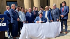 Louisiana Gov. Jeff Landry signs Act 584 in front of Memorial Tower on LSU’s campus.