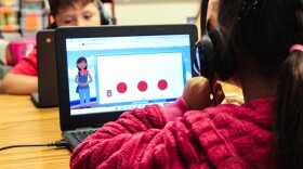 A first grader reads with the help of an AI-powered tutor at Johnson Elementary in Gretna on Sept. 23, 2023.