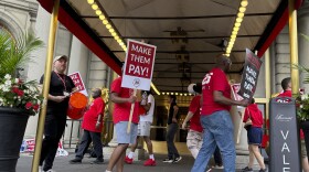 Hotel workers on strike chant and beat drums while picketing outside the Fairmont Copley Plaza hotel on Sunday in Boston.