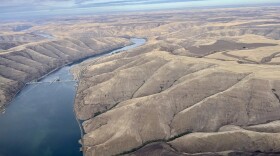 An aerial shot of a river with a dam.