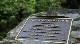 A plaque on the side of a rock at the Illahee Preserve, reading "dedicated to Audrey Boyer, teacher and Frank Chopp, her student"