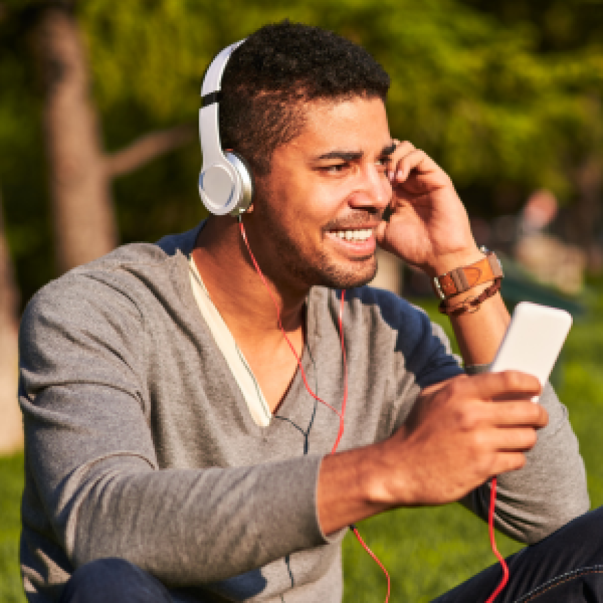 Man listening to a podcast outside