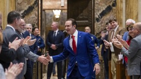 Gov. Jeff Landry shakes hands with representatives while entering the House chamber during the first day of a special session on Monday, Jan. 15, 2024, in Baton Rouge, La. (Michael Johnson/The Advocate via AP, Pool)