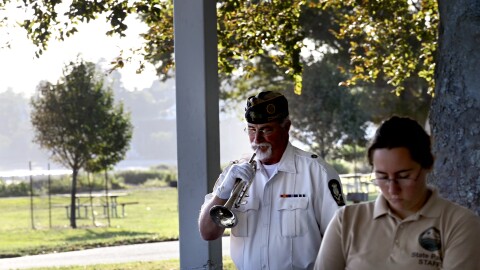 Jonathan Worley, a retired U.S. Navy serviceman, plays Taps at the annual state commemoration of the September 11 attacks at Sherwood Island in Westport on September 5, 2024.