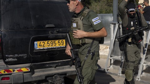 Israeli security forces secure a road near where Israel's government says a drone launched toward Israeli Prime Minister Benjamin Netanyahu's house in Caesarea, Israel, on Saturday.