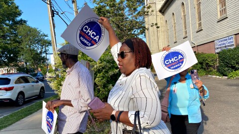 Rhonda Benn, center, a food service worker at Norwalk Hospital walks out of the Cornerstone Community Church on Wednesday night Aug. 09, 2023 after workers voted 45 to 3 to join a union.