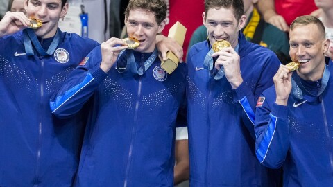 Team USA's men's swimming team stands on the podium after winning gold in the men's 400-meter freestyle relay final at the Paris Olympics on Saturday.